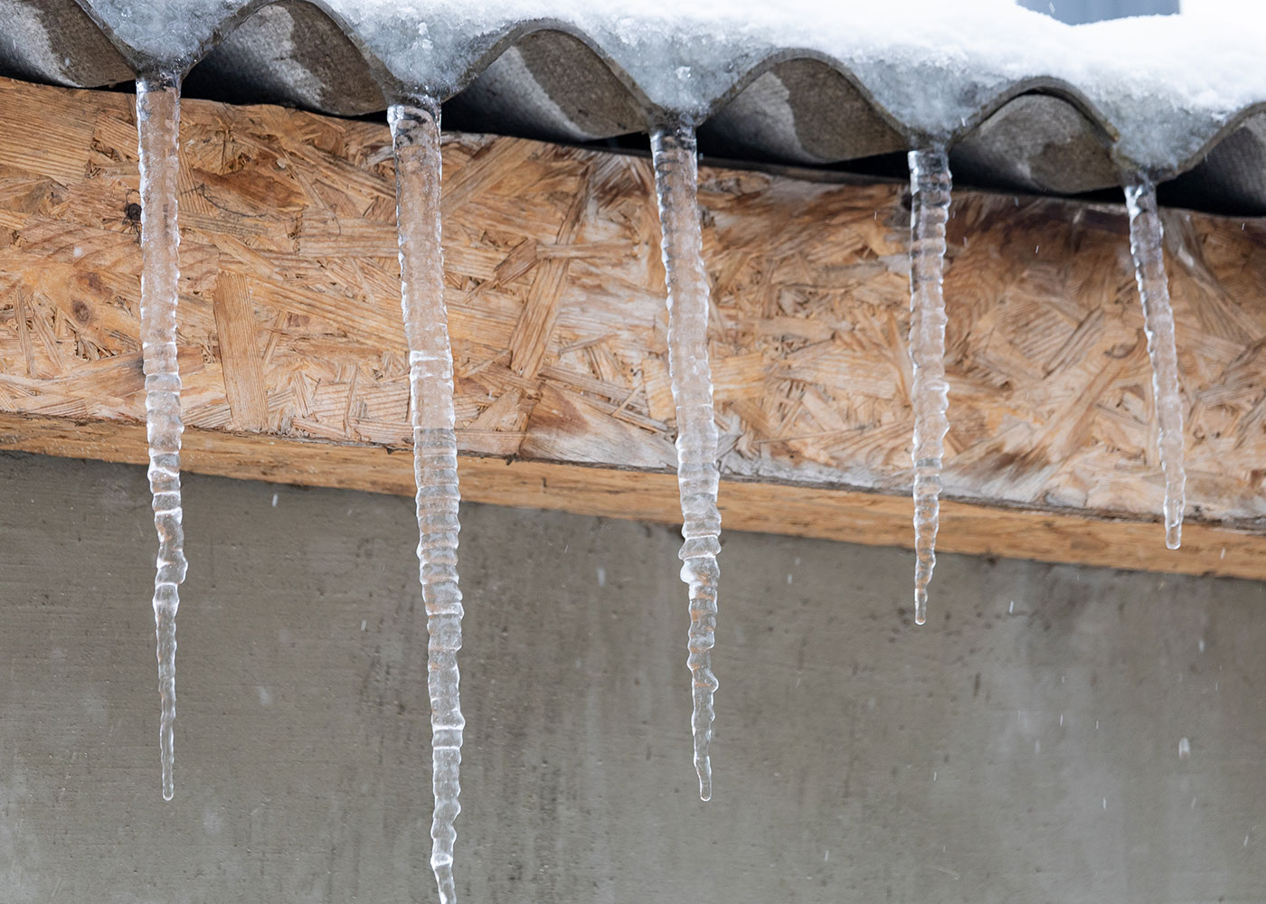 Ice dams in winter caused by uneven roof temperatures